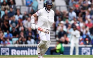 Chris Woakes strides to the crease, arm strapped in a sling.
